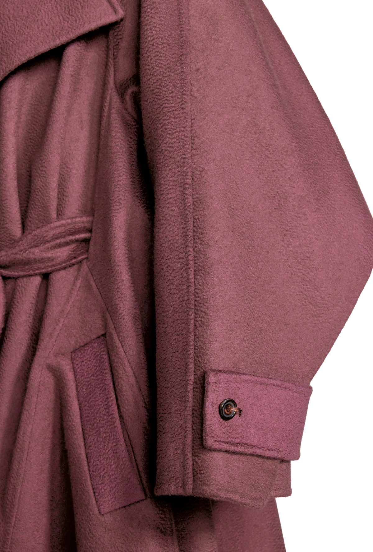 Close-up of a dusty rose or mauve-colored coat with a matching tie belt and a single buttoned cuff.