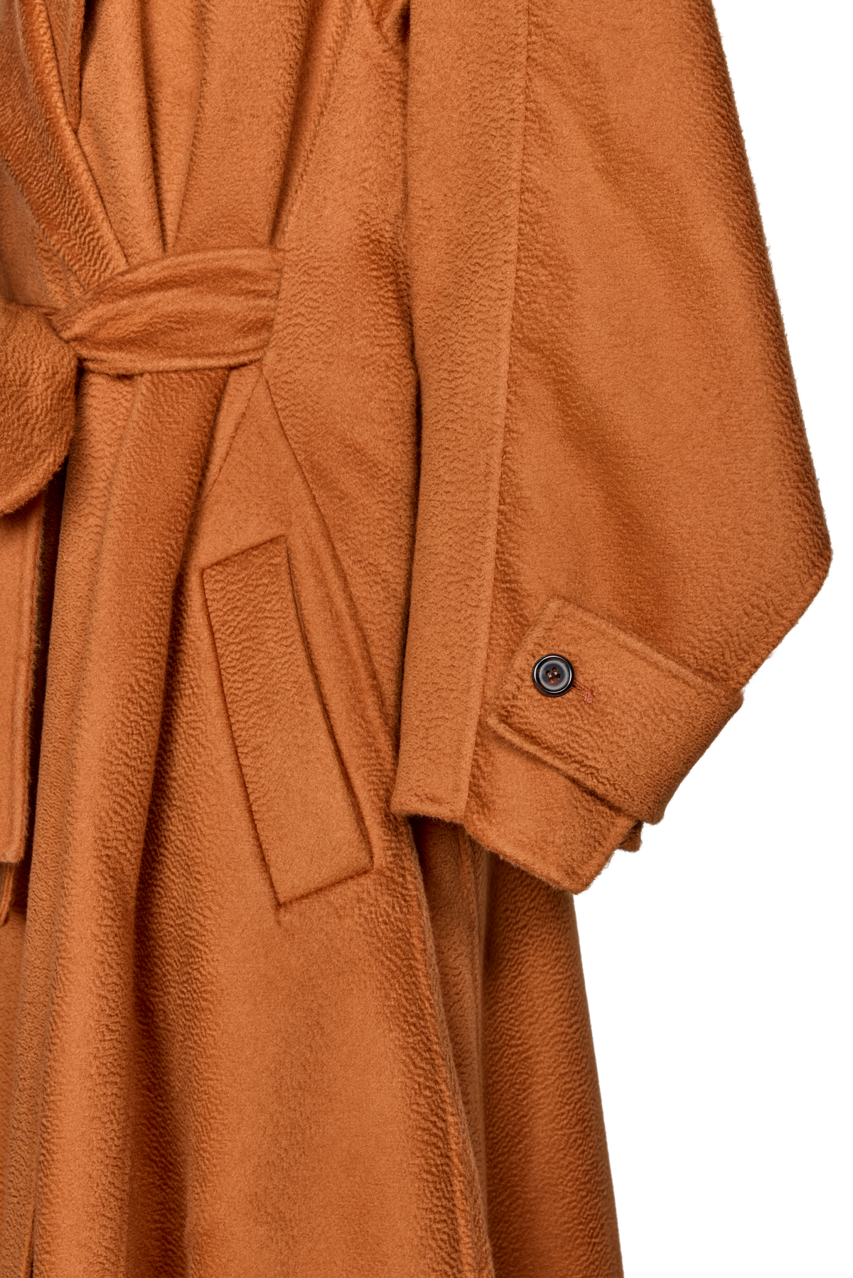 Close-up of a warm rust-brown textured coat or robe with a tie belt, flap pocket, and a single button cuff.